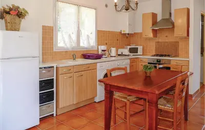 a kitchen with a wooden table and a white refrigerator at Beautiful Home In Casalabriva With Wifi in Casalabriva