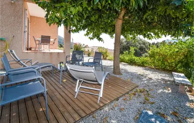 a group of chairs sitting on a deck under a tree at Beautiful Home In Casalabriva With Wifi in Casalabriva