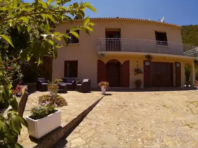 a house with a patio in front of it at Villa Emmony in Santo-Pietro-di-Venaco