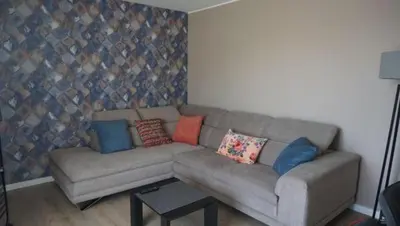 a living room with a couch with pillows on it at L'appollu in La Porta