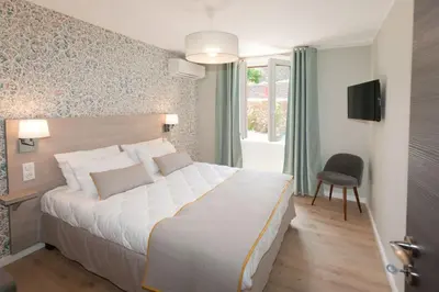 a bedroom with a large white bed and a window at L'appollu in La Porta