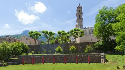 a building with a clock tower in the background at L'appollu in La Porta