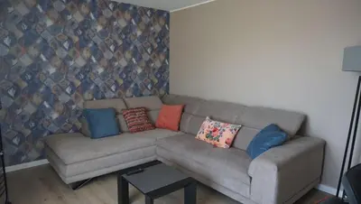 a living room with a couch with pillows on it at L'appollu in La Porta