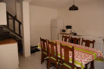 a kitchen with a table and chairs and a refrigerator at A Cittadella in Vico