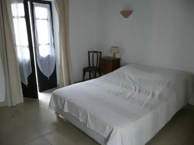 a bedroom with a white bed and a window at A Cittadella in Vico