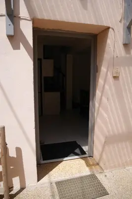 a door into a building with a door open at A Cittadella in Vico