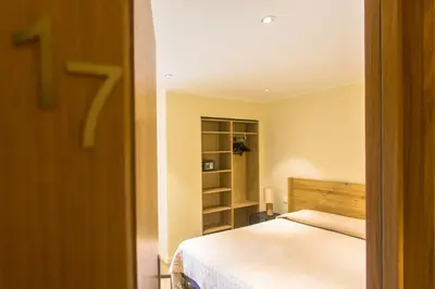 a bedroom with a bed and a book shelf at Hotel Cesario in Calvi