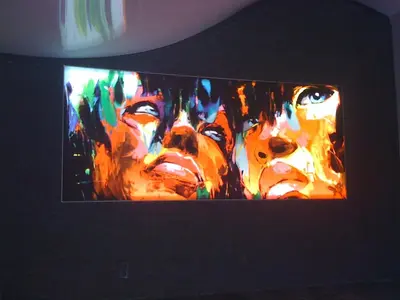 a television screen with a painting of people at Isola Hôtel in Borgo