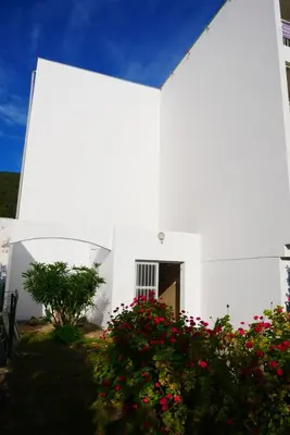 a white church with flowers in front of it at A U Mare in Sagone