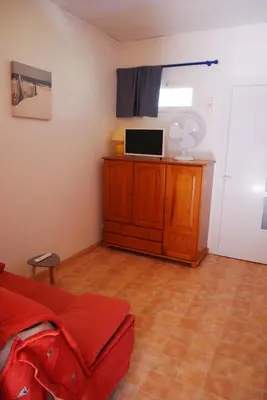 a bedroom with a bed and a desk with a window at A U Mare in Sagone