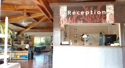 a kitchen with a bar with a restaurant sign on it at Hotel Olmuccio in Sainte-Lucie de Porto-Vecchio
