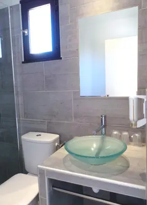 a bathroom with a sink and a toilet at Hotel Olmuccio in Sainte-Lucie de Porto-Vecchio