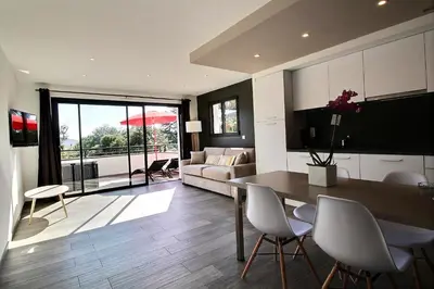 a kitchen and living room with a table and chairs at Residence ACQUA LINDA Porticcio in Porticcio