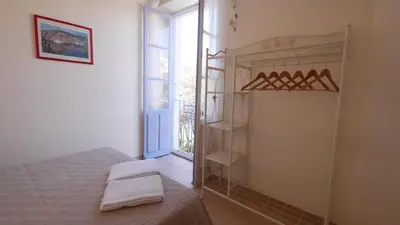 a bedroom with a bed and a window at Les Figuiers in Porto Pollo