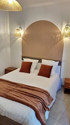 a bedroom with a large white bed with two pillows at T2 de 45 m2 sur Porticcio avec Jardin in Porticcio