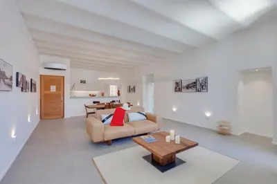 a living room with a couch and a table at Les Appartements du Port in Bonifacio