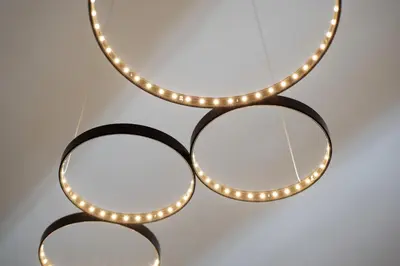 a group of three round mirrors with lights at Les Appartements du Port in Bonifacio