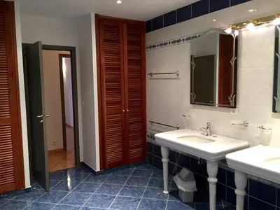 a bathroom with two sinks and a mirror at Les Appartements du Port in Bonifacio