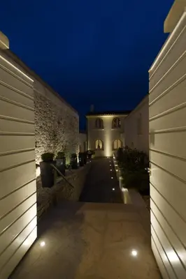 a courtyard of a house at night with lights at Hotel Spa Genovese in Bonifacio
