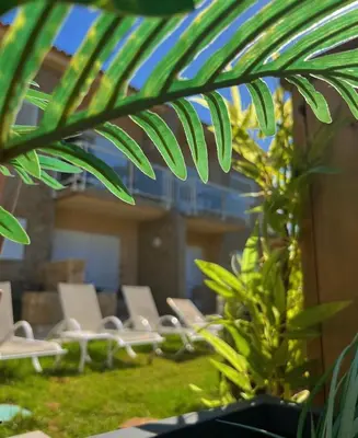 a group of chairs and plants in a building at Hôtel Lilium Maris in Sartène