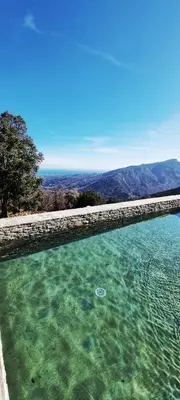 a swimming pool with a view of the ocean at Domaine Colonna-Santini Gîte avec Piscine & Spa, Vue Mer et Montagnes in Porri