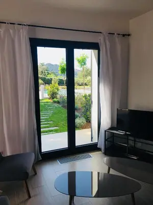 a living room with a large sliding glass door at Cantari in Calenzana