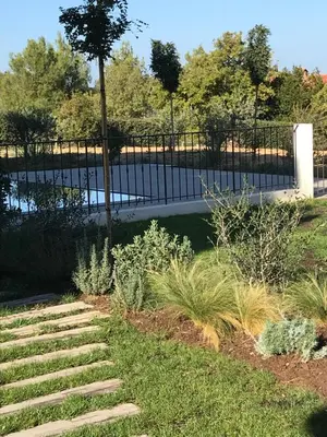 a garden with a fence and some plants at Cantari in Calenzana