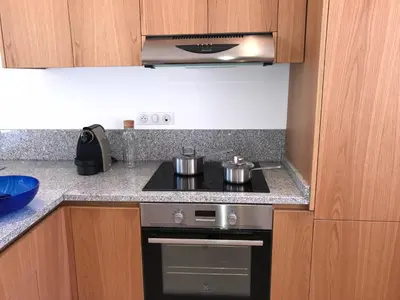 a kitchen with two pots on top of a stove at Cantari in Calenzana