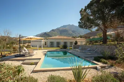 a swimming pool in a yard with a house at Cantari in Calenzana