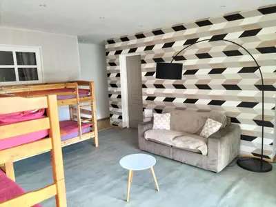 a room with a bunk bed and a couch at les JARDINS de PRATAVONE in Aja dʼOnica