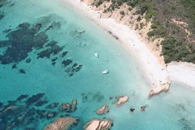 an aerial view of a beach with people in the water at Casa Di Minnana in Petreto-Bicchisano