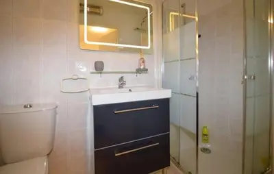 a bathroom with a sink and a toilet and a mirror at Casa Di Minnana in Petreto-Bicchisano