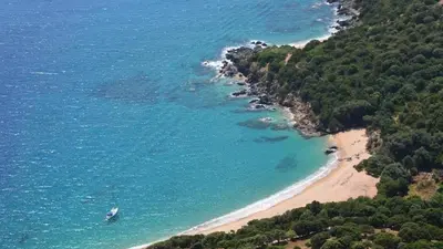 an aerial view of a beach with a boat in the water at Casa Di Minnana in Petreto-Bicchisano