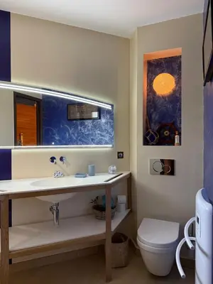 a kitchen with a table and chairs and a refrigerator at L'Hacienda Piscine chauffée à 28, spa, boulodrome et court de Tennis privés, 2 villas indépendantes in Porto-Vecchio