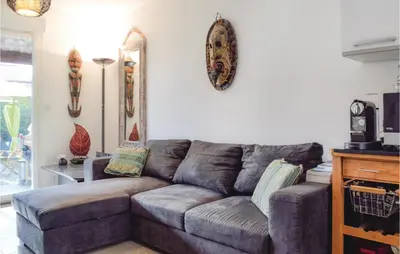a living room with a gray couch in a room at 3 Bedroom Gorgeous Home In Cervione in Cervione