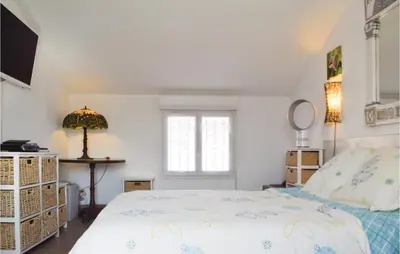 a bedroom with a bed and a window at 3 Bedroom Gorgeous Home In Cervione in Cervione