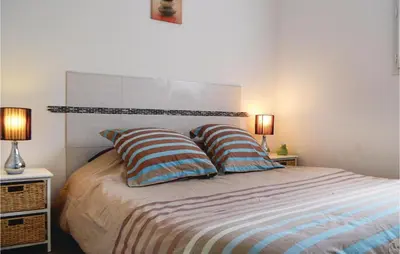 a bedroom with a bed with two pillows on it at 3 Bedroom Gorgeous Home In Cervione in Cervione