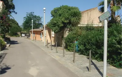 a street with street lights on the side of a road at 3 Bedroom Gorgeous Home In Cervione in Cervione