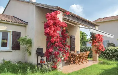 a bunch of red flowers on the side of a house at 3 Bedroom Lovely Home In Cervione in Cervione