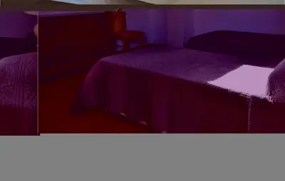 two pictures of a bedroom with a bed and a chair at 3 Bedroom Lovely Home In Cervione in Cervione