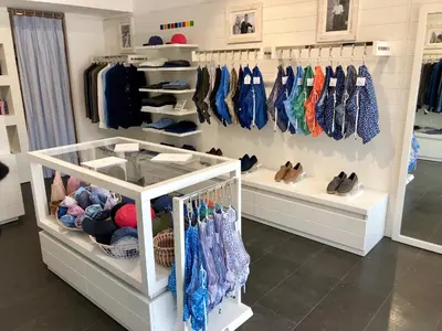 a walk in closet with clothes and shoes on racks at Hotel Centre Nautique in Bonifacio
