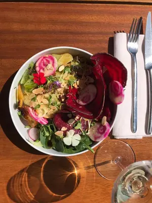 a salad in a white bowl on a table at Hotel Centre Nautique in Bonifacio