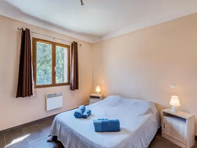 a bedroom with a bed and a window at Holiday Home A Mandria by Interhome in Ghisoni