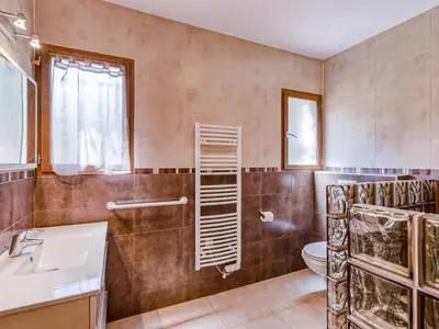 a bathroom with a toilet and a sink and a mirror at Holiday Home A Mandria by Interhome in Ghisoni