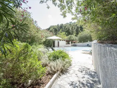 a garden with a swimming pool and some plants at Holiday Home A Mandria by Interhome in Ghisoni