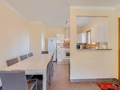 a kitchen with a large wooden table and chairs at Holiday Home A Mandria by Interhome in Ghisoni