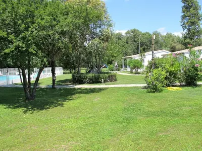 a park with trees and grass and a sidewalk at Holiday Home A Suara-1 by Interhome in Ghisonaccia