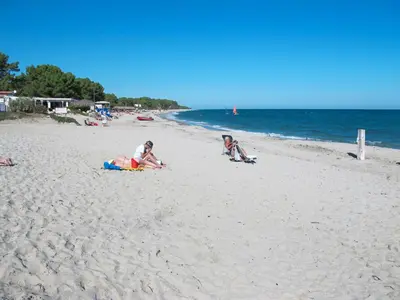 a group of people playing on the beach at Apartment A Suara di Mare by Interhome in Ghisonaccia