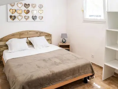 a white bedroom with a large bed and a window at Apartment A Suara di Mare by Interhome in Ghisonaccia
