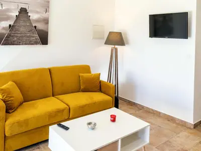 a living room with a yellow couch and a coffee table at Apartment A Suara di Mare by Interhome in Ghisonaccia